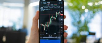 a person holding a cell phone in their hand