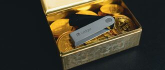 a swiss army knife sitting in a box of gold coins