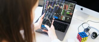 a woman sitting at a desk using a laptop computer