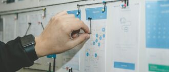 person working on blue and white paper on board